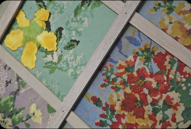 Painted flowers divided by wooden grid.