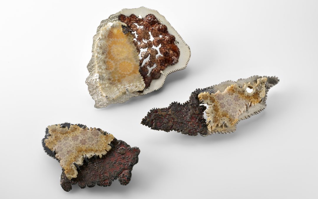 Three individual pieces of coral with decorative halves added to them.