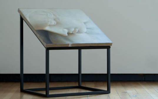 A work by Justine Varga, a dimly lit image of a window with draping curtains