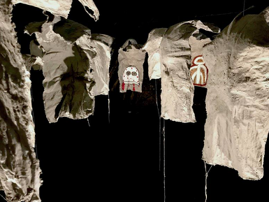 A work by Justine Varga, a dimly lit image of a window with draping curtains